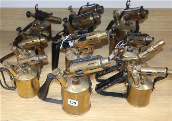 A collection of twelve brass blow torches, various sizes and makers